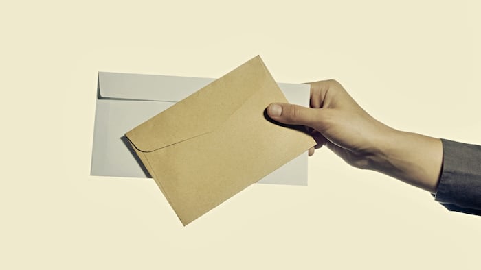 Hand holding two envelopes