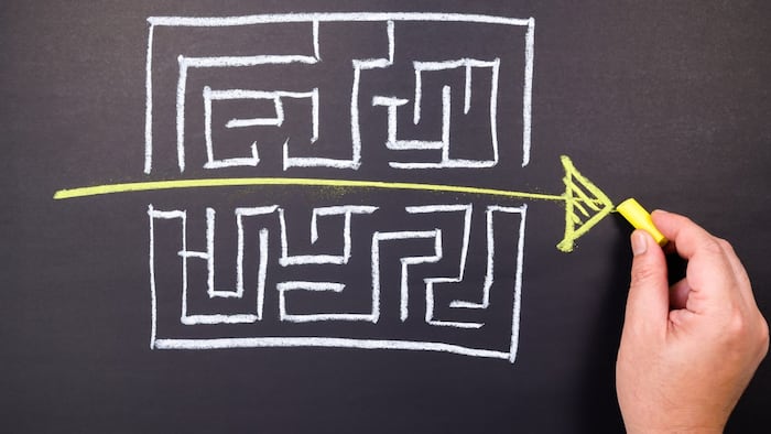 Hand draw a shorten straight way to go through the complication of a maze game, easier process, simplify in communication, or fast solution concept