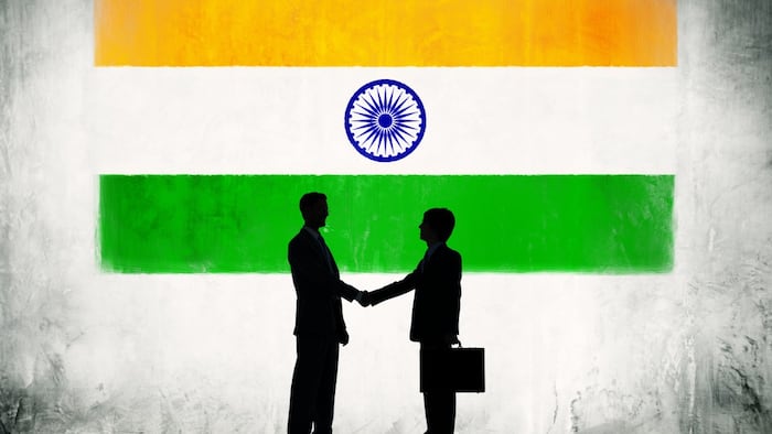Two Businessmen Shaking Hands With Flag of India