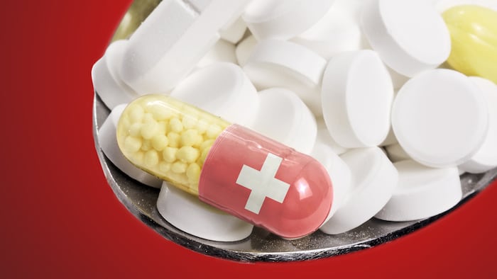 The Flag Of Switzerland With Pills On A Spoon