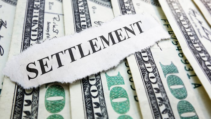 Settlement newspaper headline on money