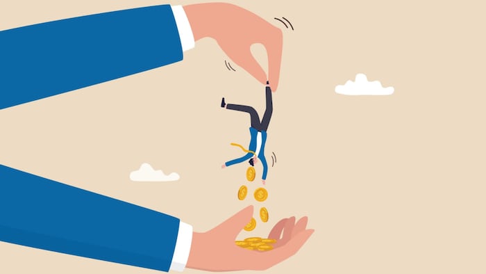 Businessman shakes coins out of tiny man